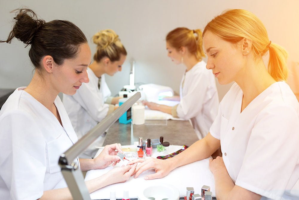 Young attractive beautician students practising during courses